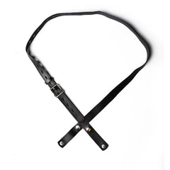Black PU-01 faux-leather chastity belt laid flat, showing the buckle and crossed front straps