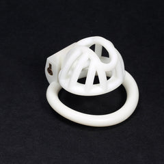 White small 3D-printed chastity cage on a dark background
