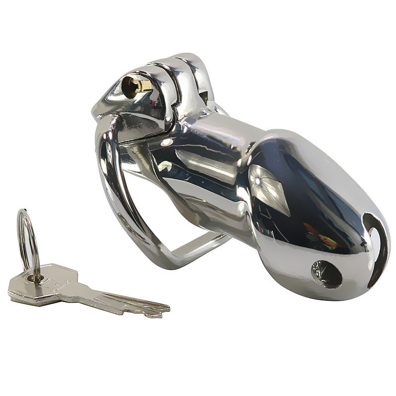 Assembled Holy Trainer V1 steel cage with fitted base ring, integrated lock and a key beside it
