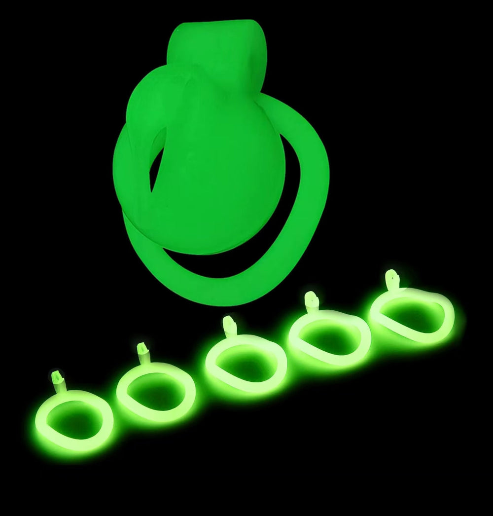 Green glowing Pussy A ABS cage displayed with five base rings
