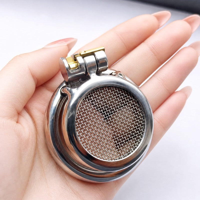 Mesh-front stainless steel chastity cage shown in hand for scale