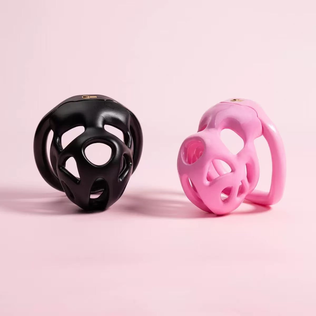Pink and black openwork resin chastity cages